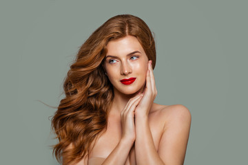 Red head girl. Beautiful ginger hair and red lips makeup. Perfect red haired woman portrait