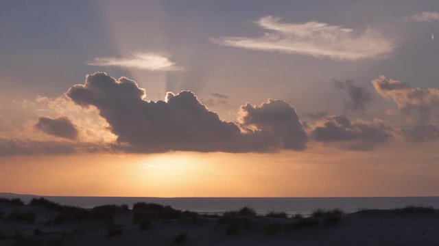 Time lapse of a sunset at the beach in Holland with some expressive clouds