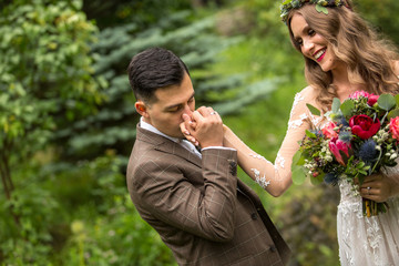 Fototapeta premium Beautiful wedding couple posing outdoor in nature