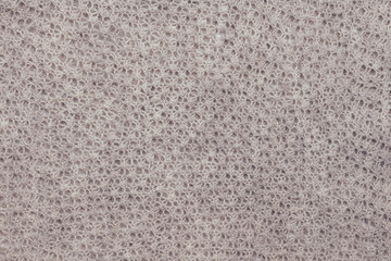 Beautiful pastel knitted fabric with visible knitted pattern. Close up. Copy space.