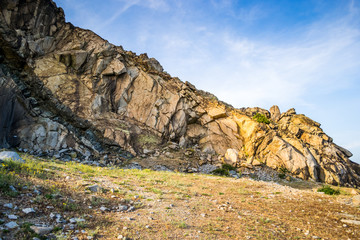 Ancient granite quarry in Romania, Macin mountains, Dobrogea region, lit in the warm light of the sunset, during a hot Autumn day