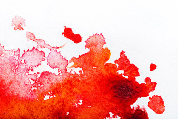 top view of red watercolor spill on white background