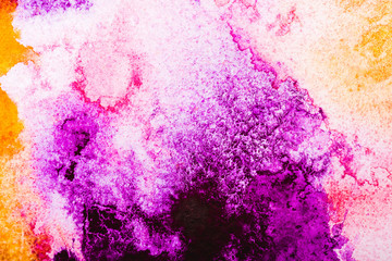 top view of orange and pink watercolor spills on white background