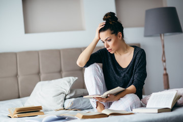 Exhausted young woman learning