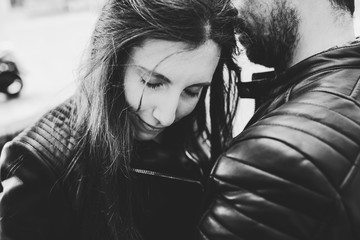 Black and white photo of woman leaning on the shoulders of a friend looking for comfort before a sentimental problem, divorce concept.