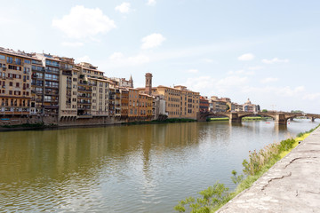 Fototapeta premium Bridge across the Arno River, Florence, Italy with palazzos lining the bank