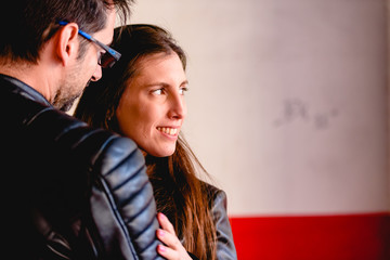 Loving couple loved embracing each other in a garden of a city hidden from prying eyes.