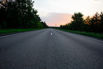 Fototapeta premium Empty straight road at sunrise