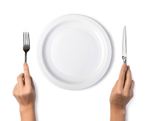 Woman hands holding a silver fork and knife