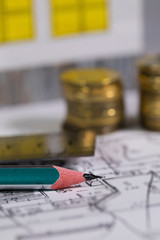 Coal pencil and metal ruler on a technical drawing of an apartment.