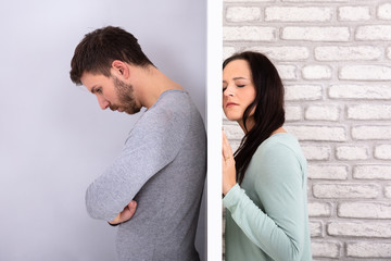 Unhappy Couple Standing Back To Back