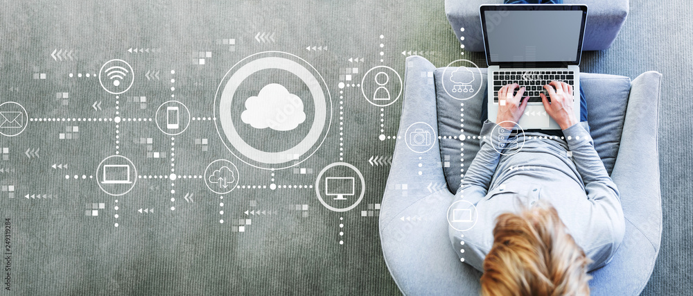Aufkleber cloud computing with man using a laptop in a modern gray chair