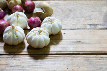Artistic onion and garlic on wooden table