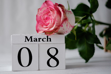 International Women's Day white vintage wooden block calendar date March 8, with a rose on a light background - Powered by Adobe