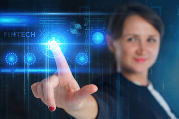 The concept of business, technology, the Internet and the network. A young entrepreneur working on a virtual screen of the future and sees the inscription: Fintech