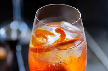 Aperol Stpritz  with bartender tools in the bar.  Classic Italian Alcoholic aperitif beverage, prepared with prosecco some bitter liqueur and soda water.