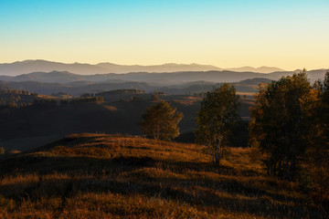 Naklejka na ściany i meble Beauty sunset in the mountains in Altay, panoramic picture. Autumn photo.