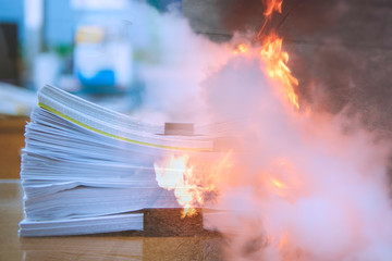 Double exposure, Stacks of paper files, Man teaches how to use fire extinguisher to extinguish fire.