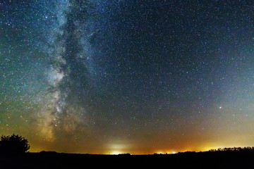 Starry sky and the milky way over the field.