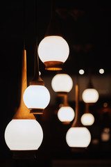 Close up many yellow lamp in cafe at night. Interiors