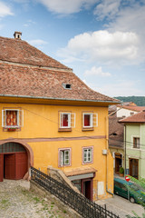 Cobble street with colored houses in Sighisoara, Romania