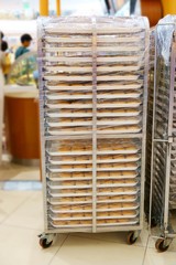Bakery rack with fresh donuts at Bakery shop