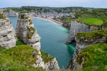 Fototapeta na wymiar Scenic alabaster chalk cliffs of Etretat and coast of Atlantic ocean, travel and vacation destination in Normandy, France