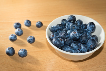 Blue berries in little white bowl.