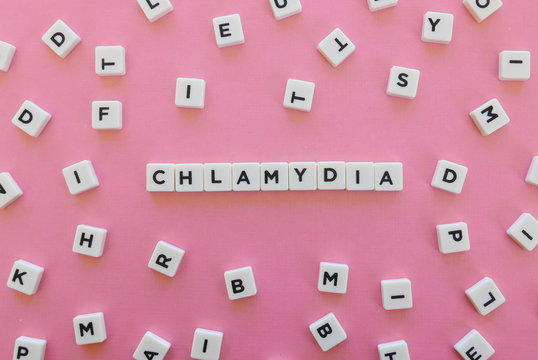 Chlamydia word made of square letter word on pink background.