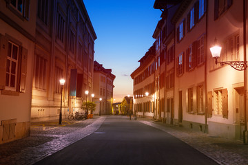 Fototapeta na wymiar Street lights of Basel old city during sunset