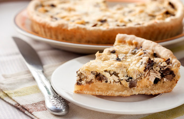 Slice of chicken tart with mushrooms and cheese
