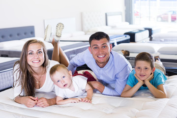 Family choosing mattress in store