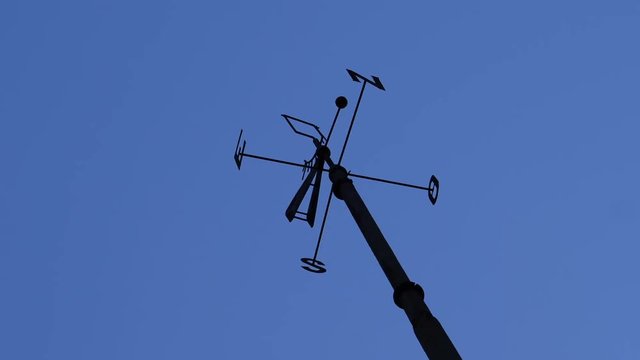 Cardinal direction pointer sign against clear blue sky in Lisbon, Portugal - North, South, East, West and their initials N, E, S, and O cut from metal