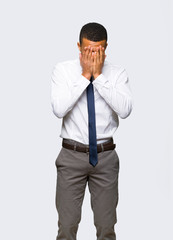 Young afro american businessman with tired and sick expression on isolated background