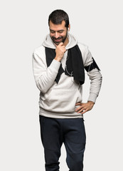 Fototapeta premium Sport man looking down with the hand on the chin over isolated grey background