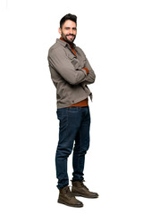 Naklejka premium Full-length shot of Handsome man with beard with arms crossed and looking forward on isolated white background