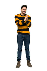 Fototapeta premium Full-length shot of Handsome man with striped sweater applauding after presentation in a conference on isolated white background