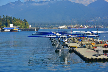Fototapeta na wymiar Seaplanes parked at dock on Coal Harbor Vancouver, BC, Canada