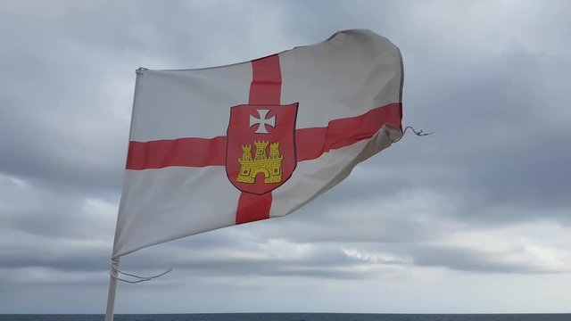 Sitges flag blowing in the wind on a cloudy day.