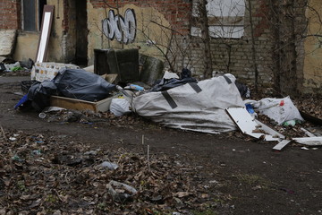 Environmental problems and nature pollution. Waste dumped in the city, an illegal social issue. Rubbish, garbage, outdoor, city, landscape, city space, abandoned area, ruined building