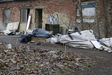 Environmental problems and nature pollution. Waste dumped in the city, an illegal social issue. Rubbish, garbage, outdoor, city, landscape, city space, abandoned area, ruined building