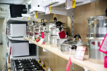 A set of stainless steel utensils on the shelves of the store, close-up