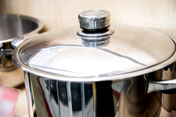 A set of stainless steel utensils on the shelves of the store, close-up