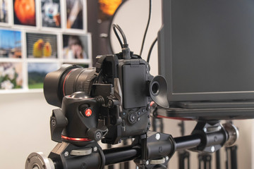 A camera and other professional equipment in modern photo studio