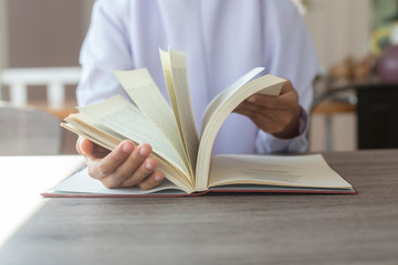 Women Muslim students studying and reading with books in  library,concept:Development of learning and education,workplace for knowledge outside the classroom,female young open textbook school