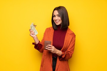 Young woman with coat holding a wallet