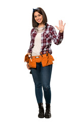 A full-length shot of a Young worker woman saluting with hand with happy expression over isolated white background