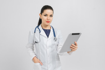 Portrait of woman in white robe with tablet in hands isolated on white background