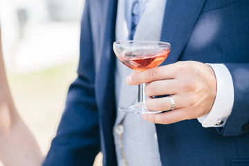 Man carrying a glass of rosé wine