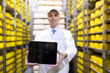 Worker shows an empty screen digitizer in stock cheese